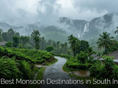 A clean, natural, high-resolution 16:9 landscape photograph of the misty, lush green hills and winding roads of the Western Ghats during the monsoon season, completely free of text overlays, infographics, and people.