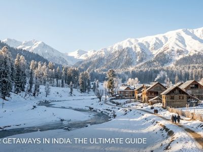A picturesque snowy landscape of the Auli ski resort in Uttarakhand, featuring bright yellow cabins set against steep slopes and towering Himalayan peaks.