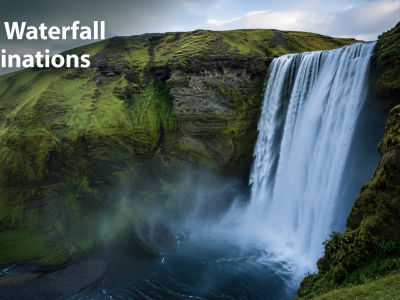 A panoramic landscape shot of a massive, multi-tiered tropical waterfall system surrounded by lush green rainforests under a bright sky.