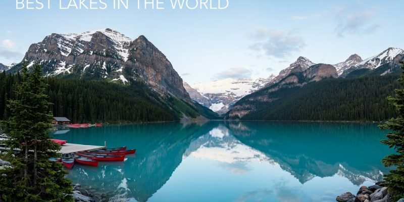 landscape of a pristine blue lake surrounded by mountains, featuring